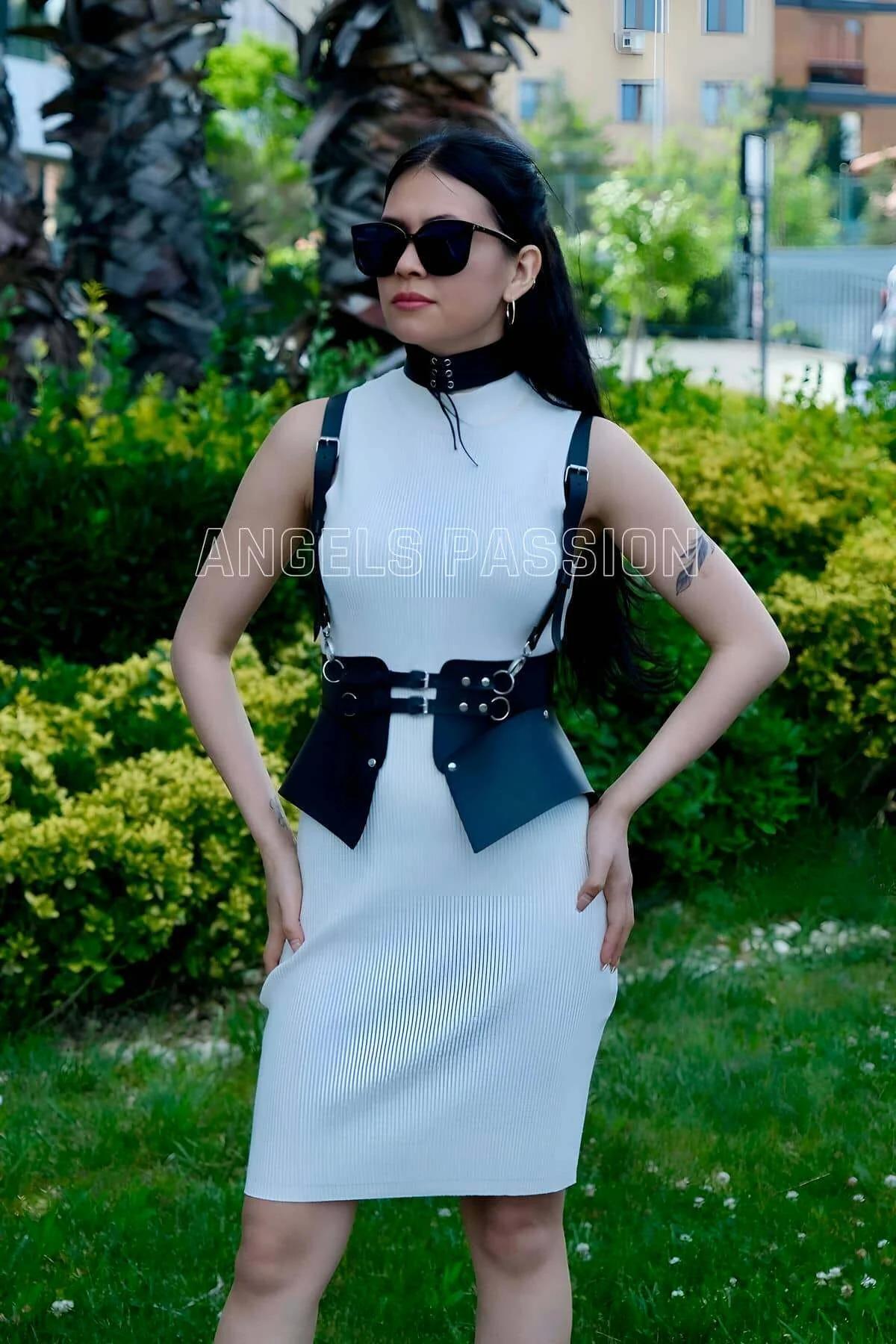Close-up of black faux leather waist harness double-buckle closure with silver O-rings on wide belt