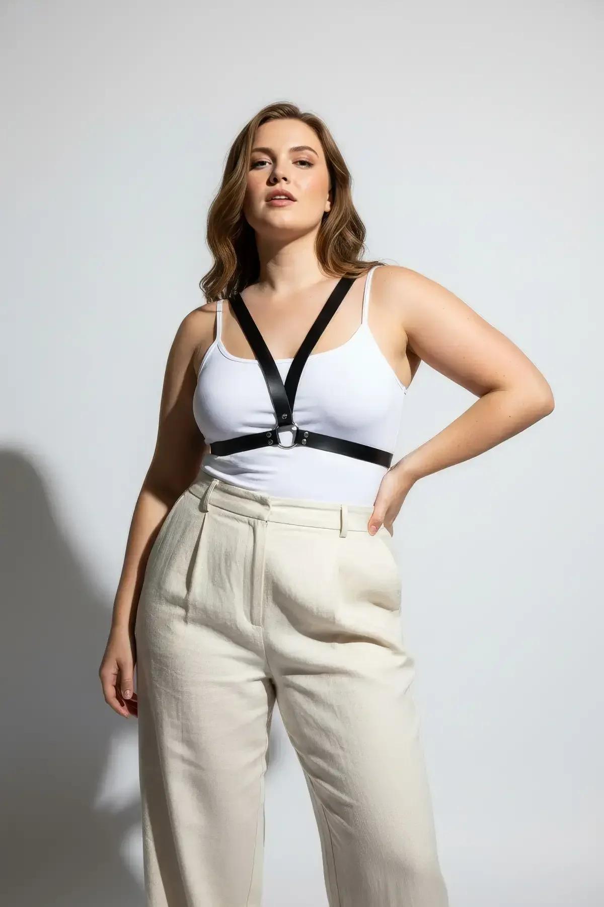black vegan leather chest harness with silver zinc alloy O-ring layered over cream ribbed tank