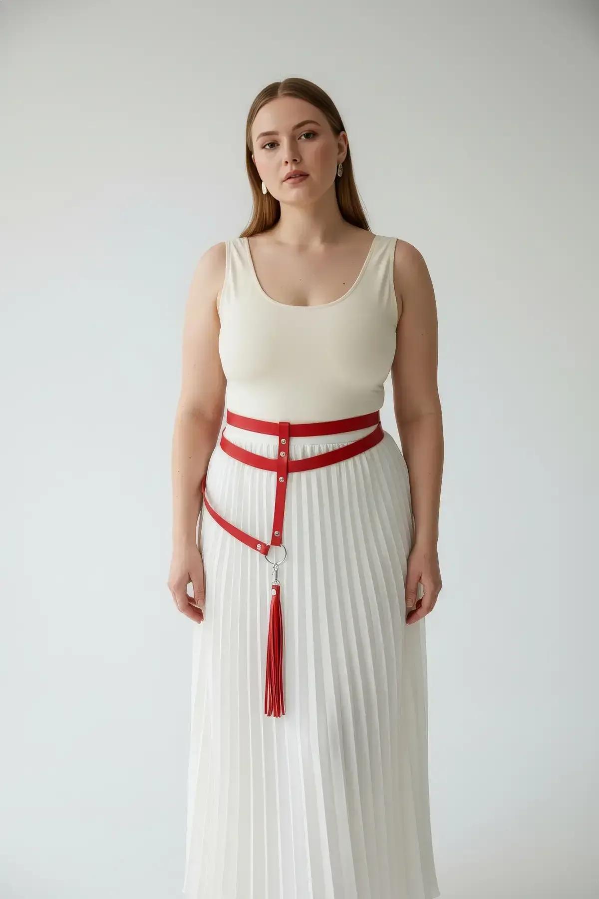 Red waist harness with tassel thigh straps detail showing clip attachment mechanism on lower O-rings