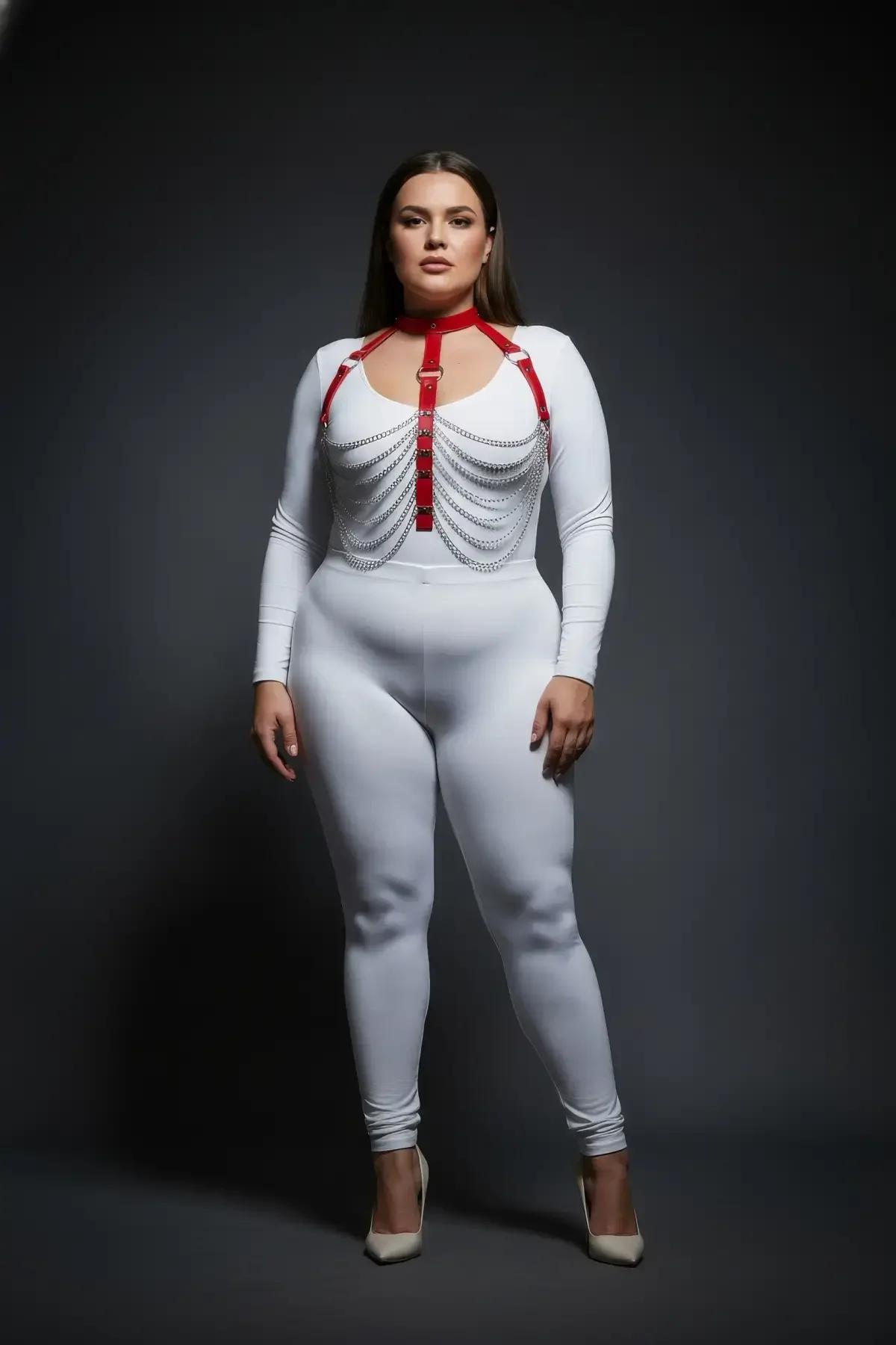 side view of red faux leather harness with layered silver chains over white bodysuit