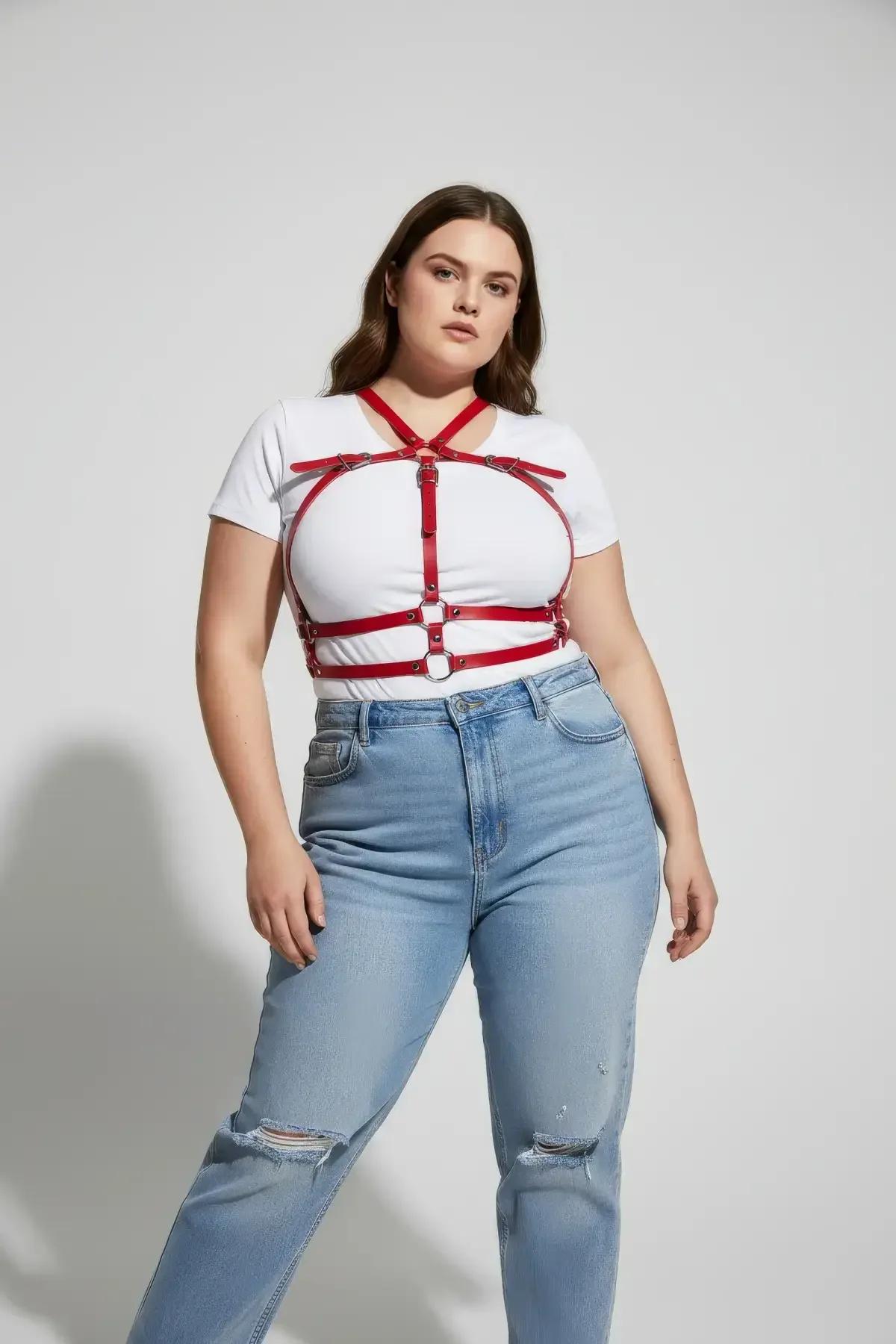 close-up of red PU faux leather straps and gold-tone O-ring connectors on caged chest harness