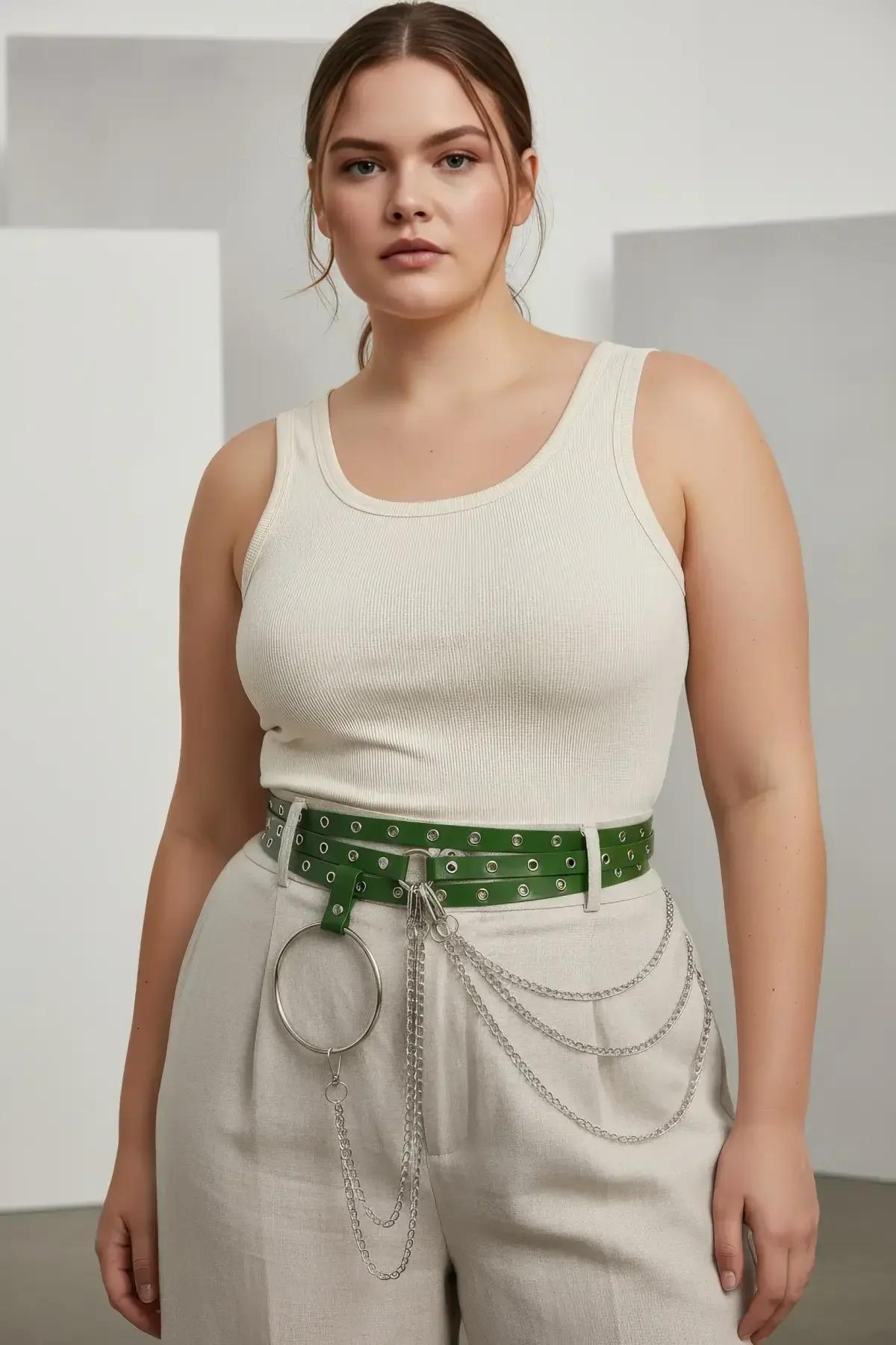 Green grommet belt silver O-ring chain detail close-up showing dual draping chain loops below waistline
