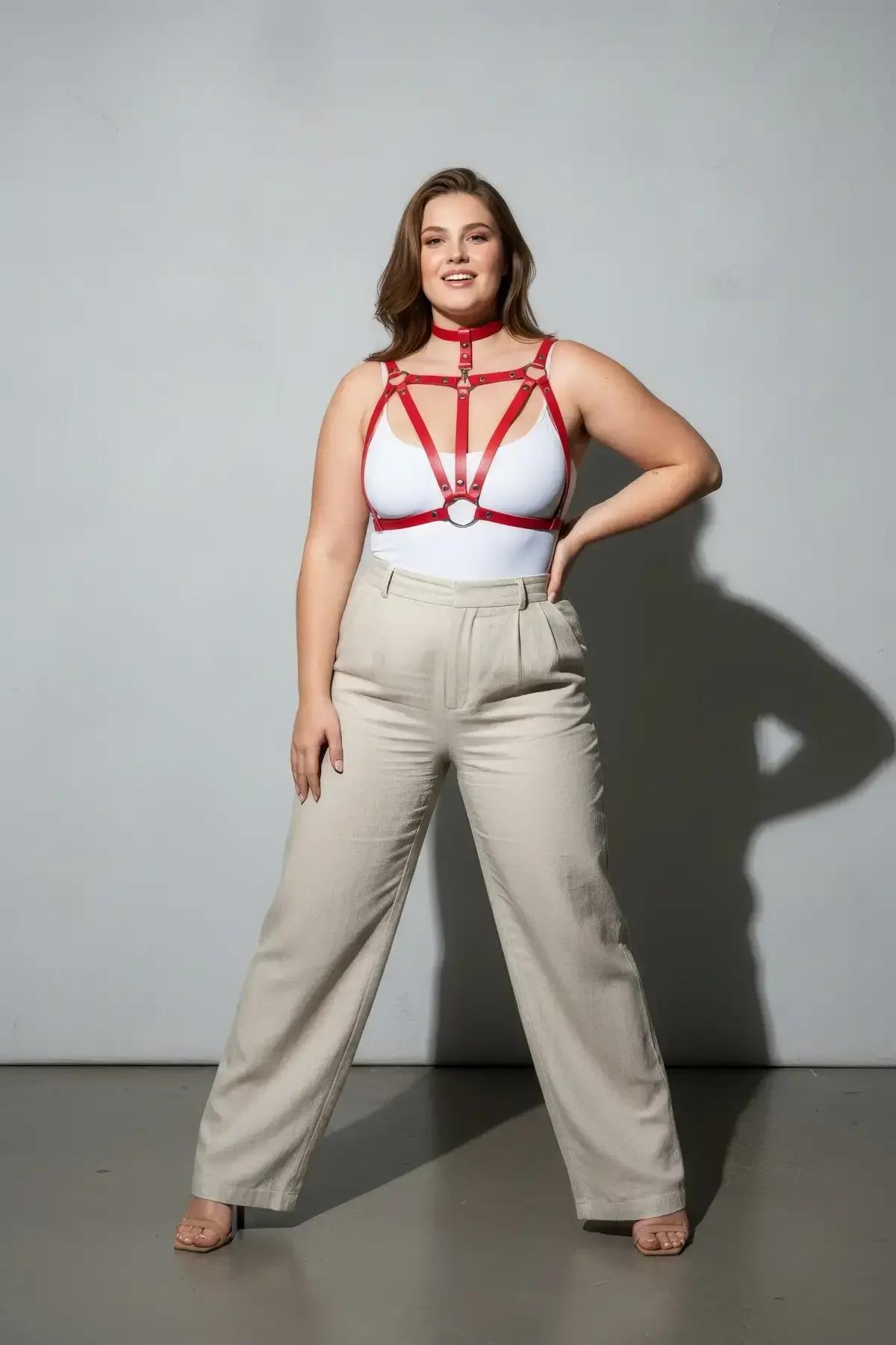 Red vegan leather chest harness layered over cream bodysuit, festival boudoir styling