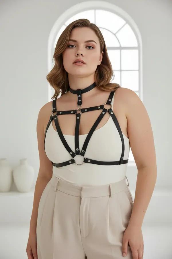 black faux leather cage chest harness with integrated choker and silver O-ring detail worn over cream top