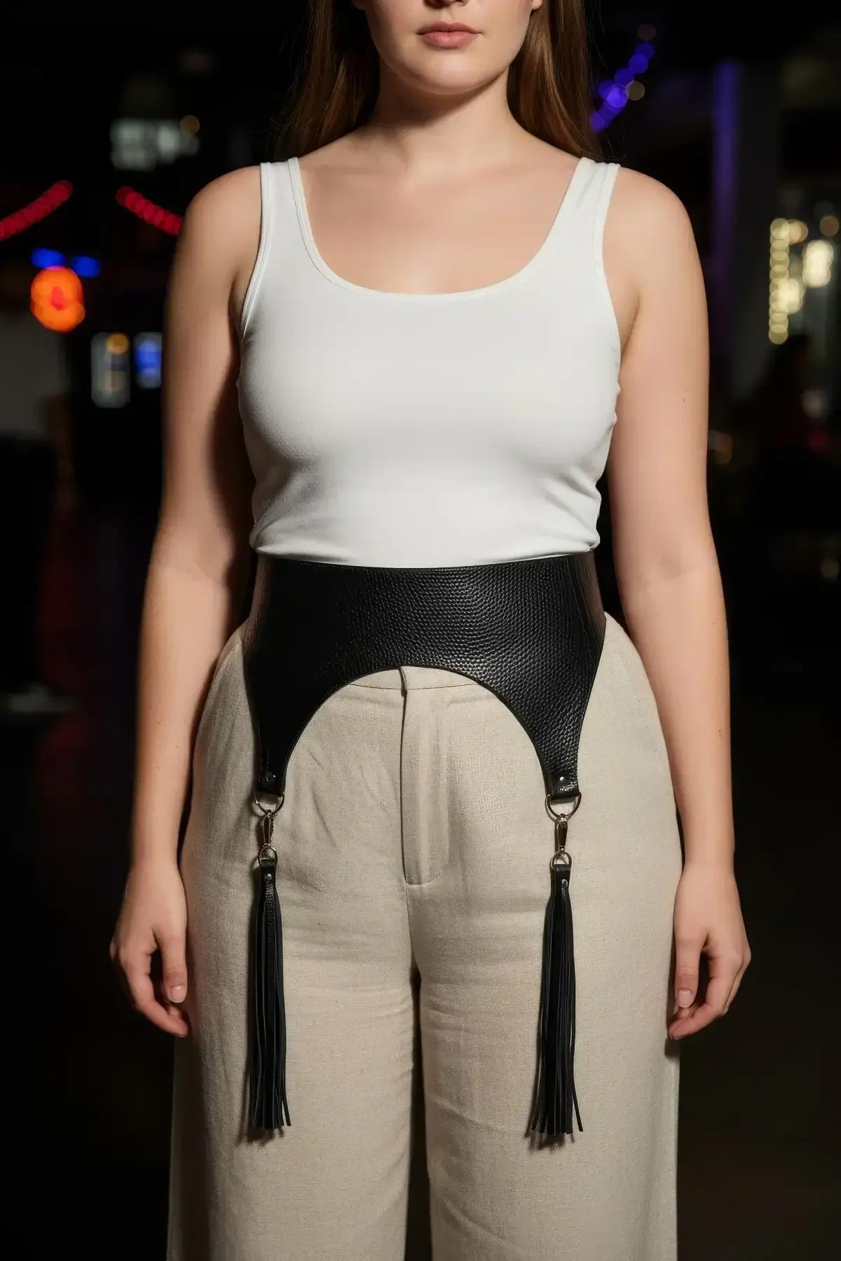black wide waist harness with tassels styled over white linen outfit, full body side angle