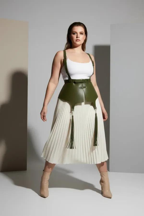 khaki faux leather waist harness olive green with long tassels and silver buckle shoulder straps worn over cream tank top