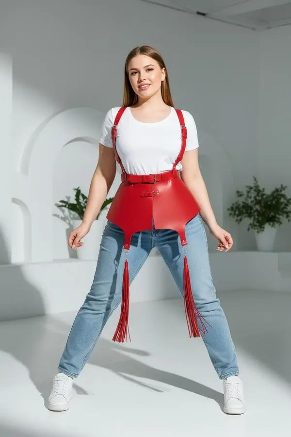 red vegan leather waist cincher harness with four tassels and adjustable shoulder straps worn over white tank top