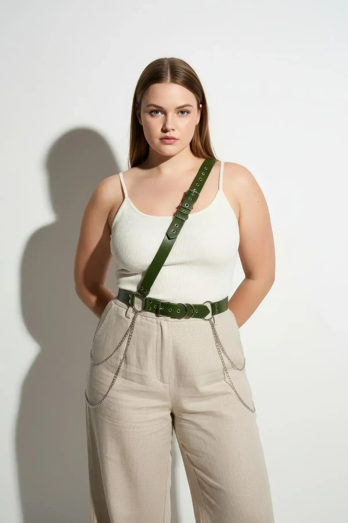 silver fine-gauge chain links on dark green faux leather harness side detail flat lay