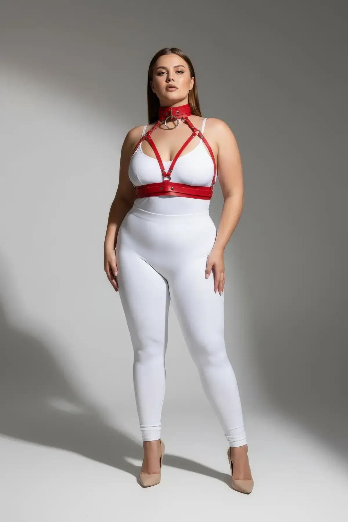 red faux leather harness bra with gold-tone O-ring detail at sternum close-up