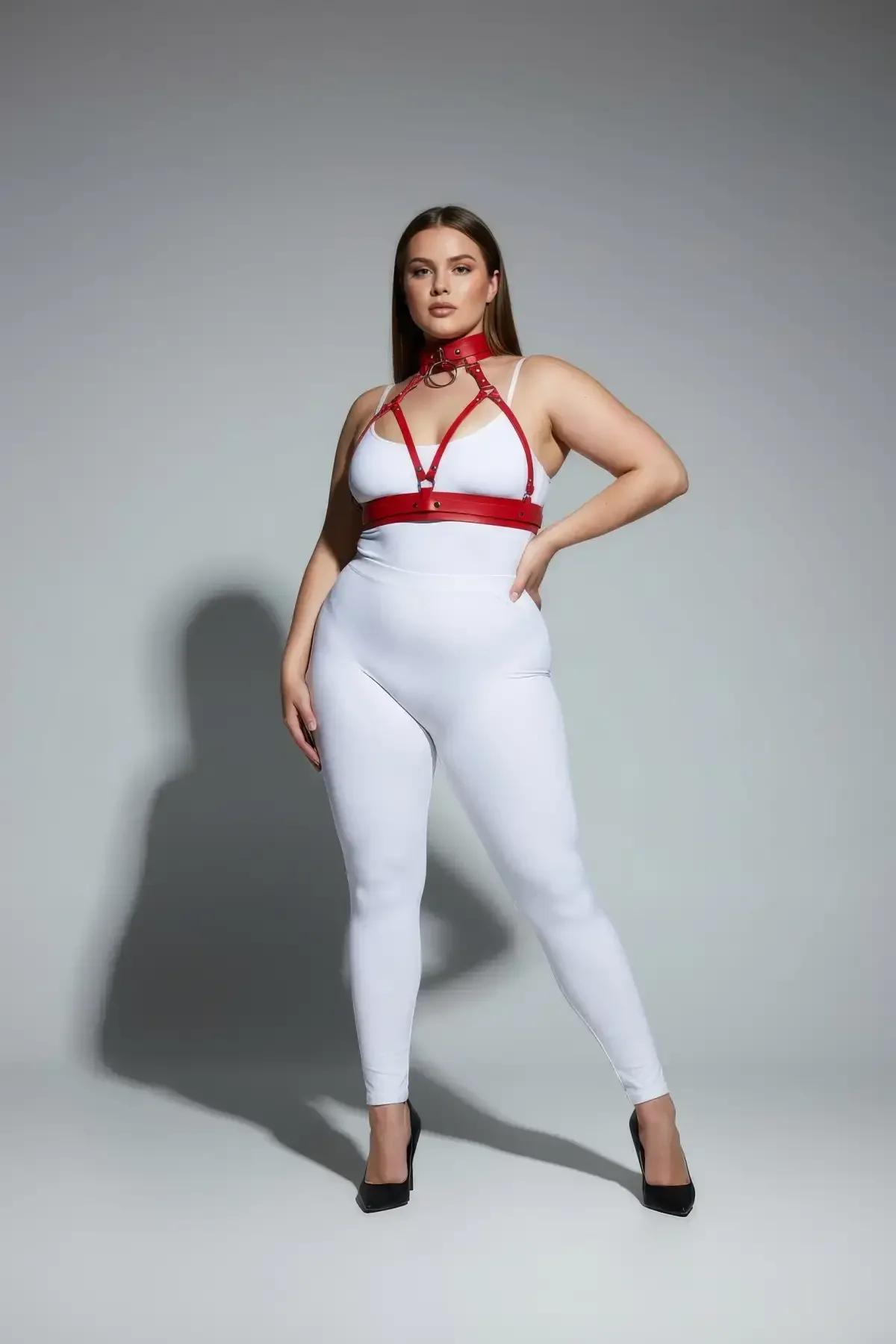 red strappy chest harness with choker worn over white bodysuit full length view