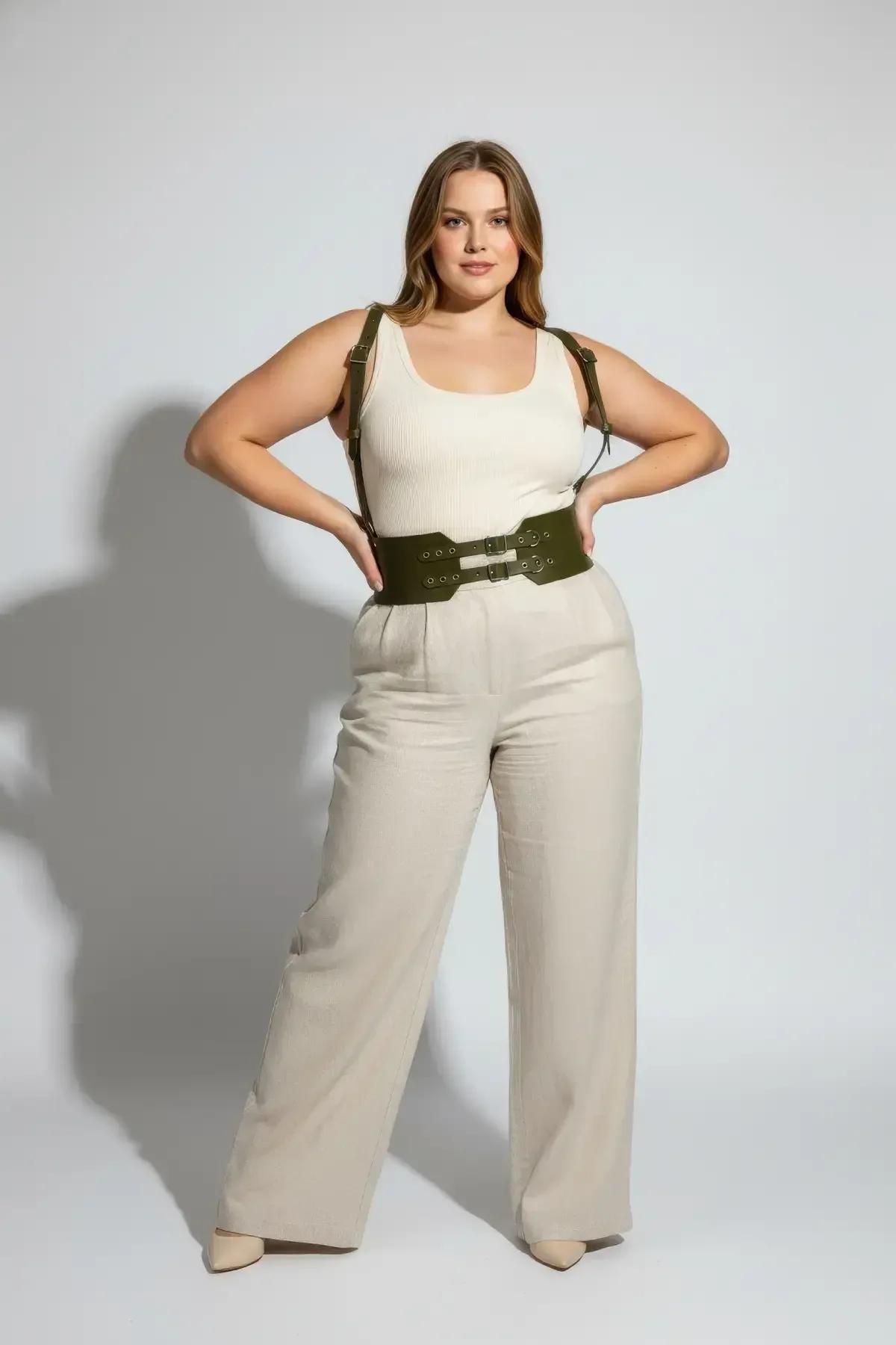 olive green wide waist harness styled over white bodysuit with beige wide-leg trousers at cafe setting