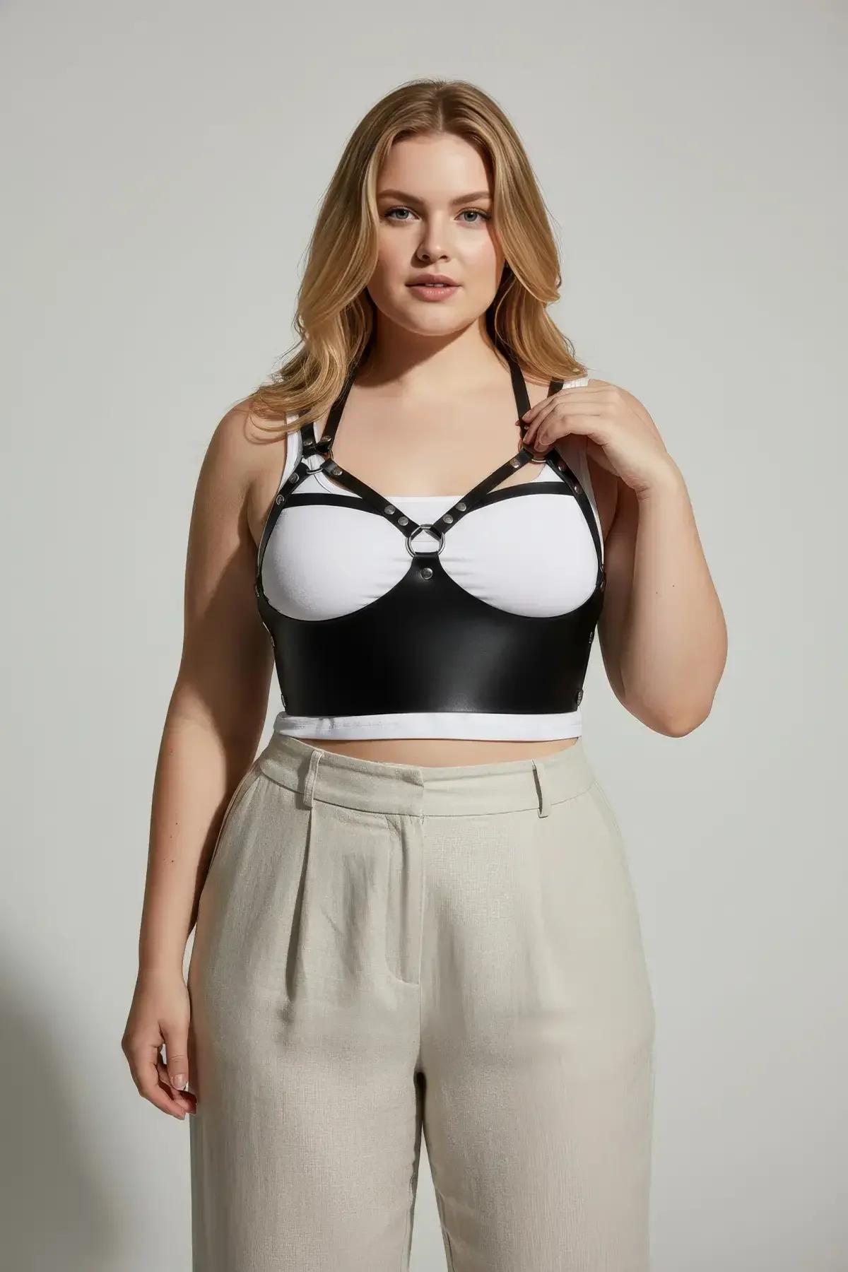 black strappy chest harness with silver O-ring worn with jeans, plus-size styling