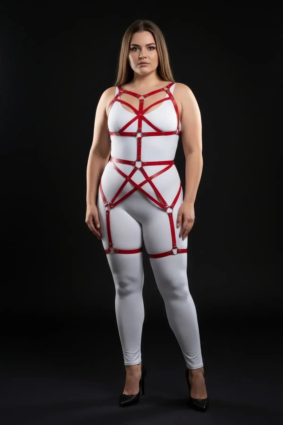 plus-size model wearing red strappy full body harness over white leggings showing thigh band placement