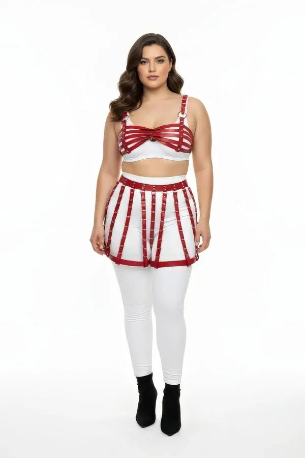 red faux leather cage skirt and bra harness set with silver O-ring and stud hardware on plus-size model