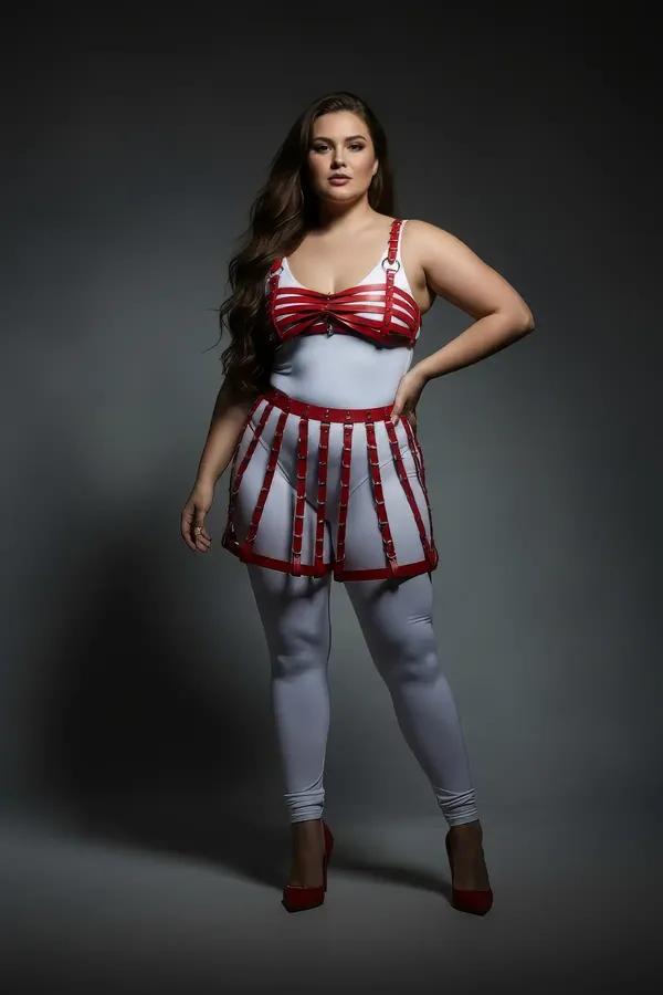 red faux leather cage skirt and bra harness set with silver O-ring and stud hardware on plus-size model