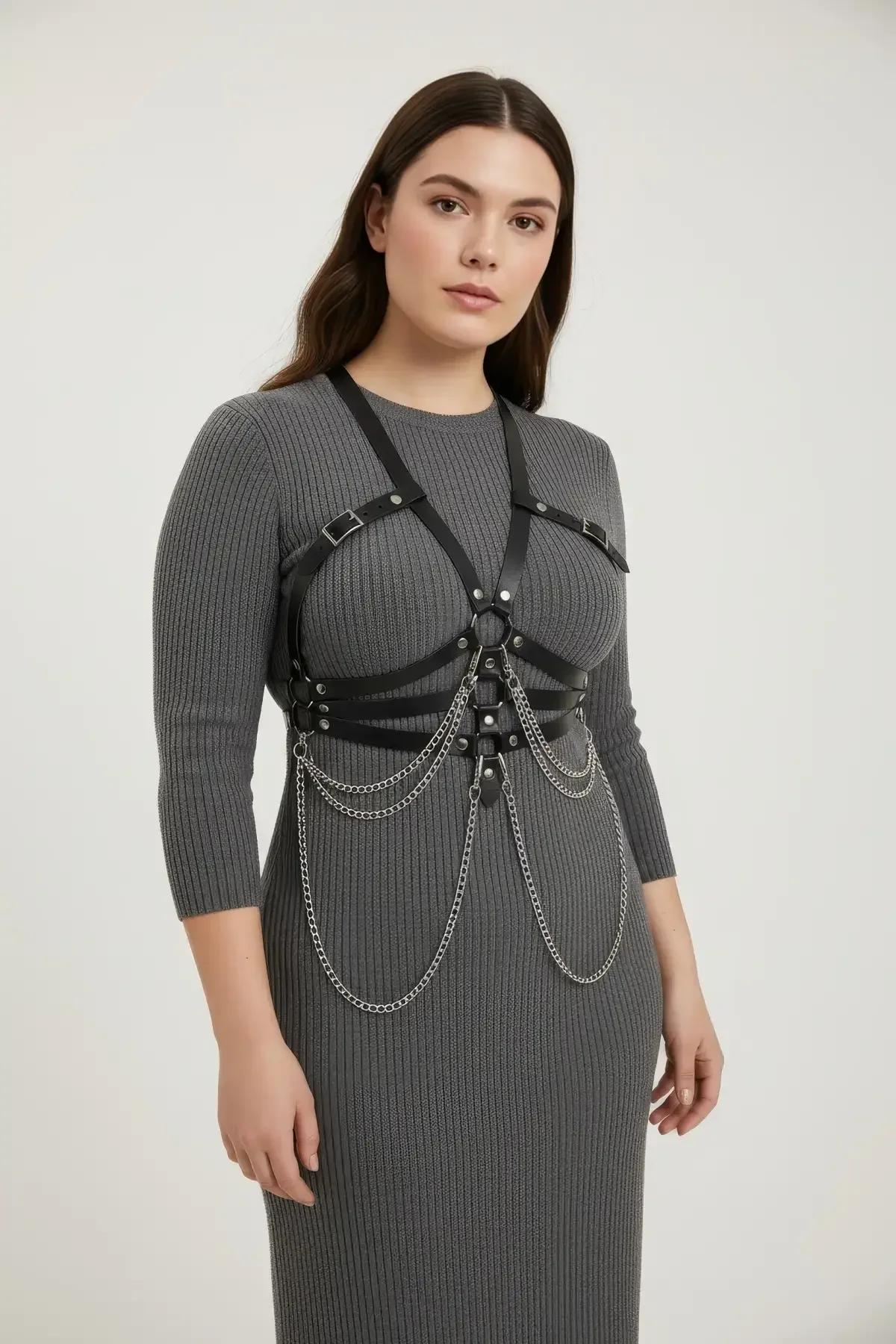 black PU body harness with four draping silver chains at hip level, front view flat lay