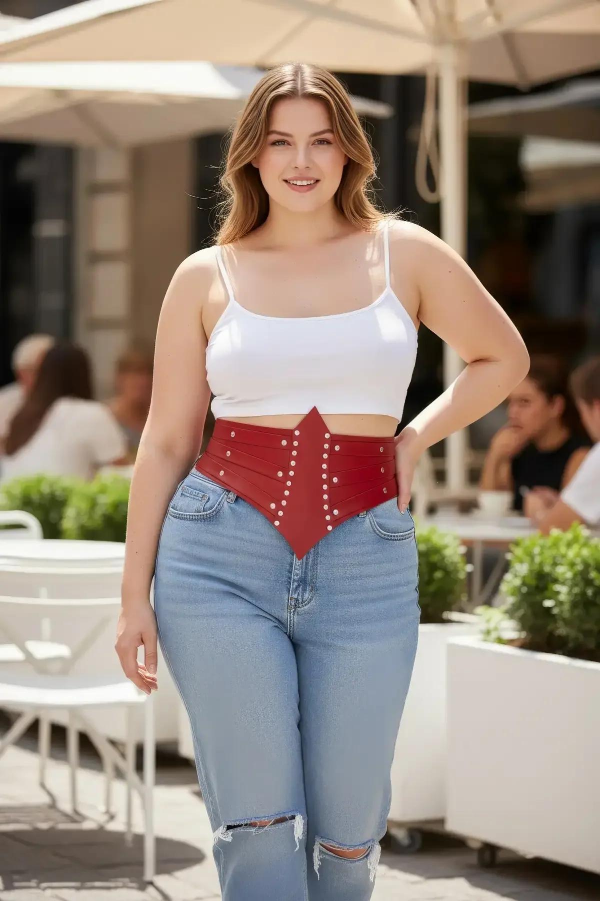 front view red studded faux leather corset belt showing V-shaped pointed front panel and silver dome hardware