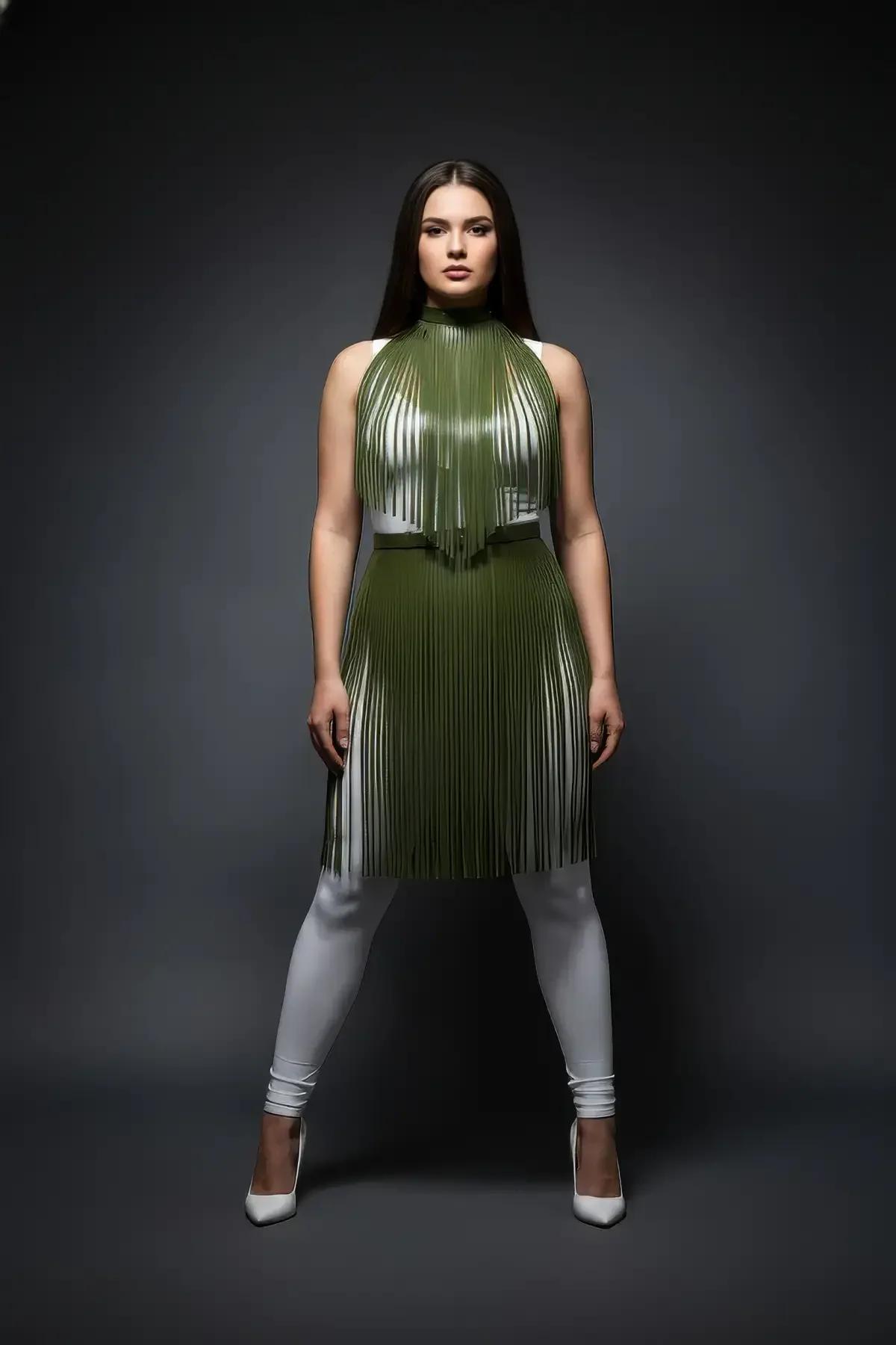 Plus size model wearing olive vegan leather fringe top over white fitted trousers and heels