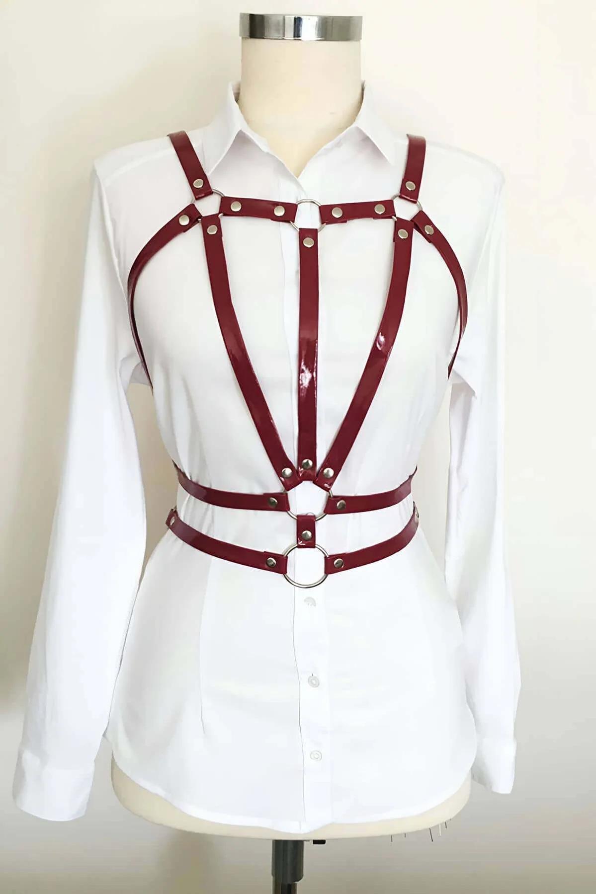dark red faux leather cage body harness silver O-ring rivet straps worn over white shirt on mannequin