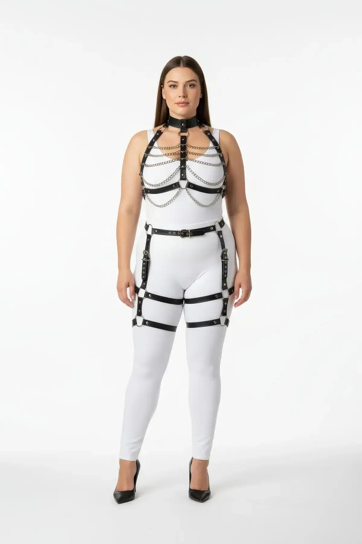 black faux leather full body harness with silver chain swags cage chest straps and thigh garter straps worn over white bodysu