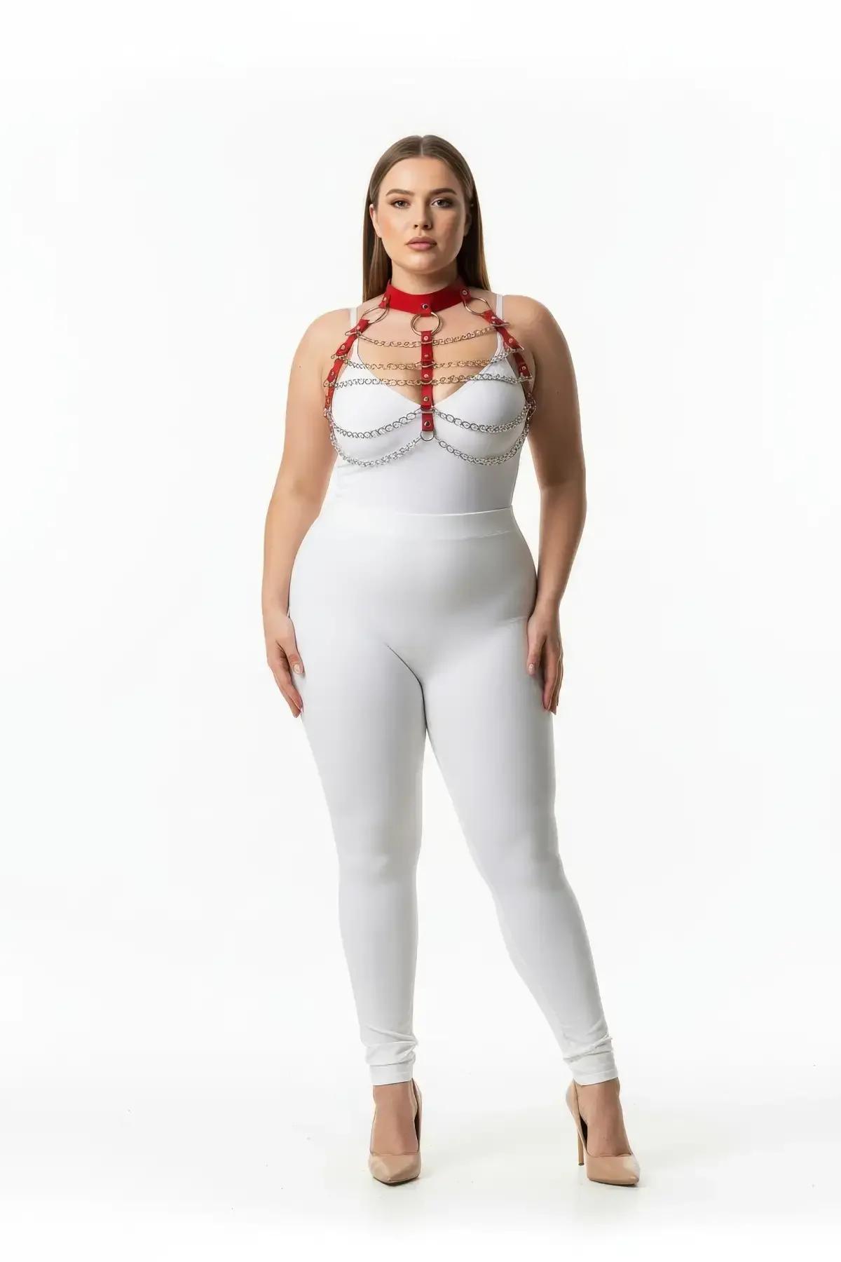 Red faux leather strappy chain body harness with silver chains and gold O-rings worn over white bodysuit on plus-size model