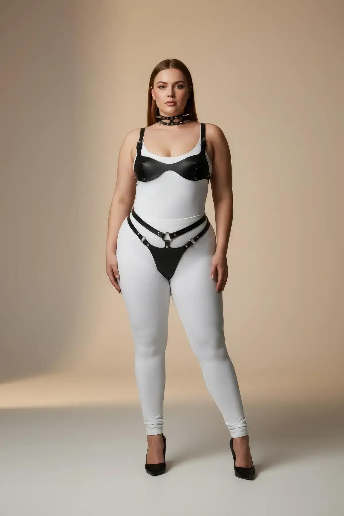 black faux leather harness set with molded bralette, dual-strap hip harness, and studded silver O-ring choker worn over white