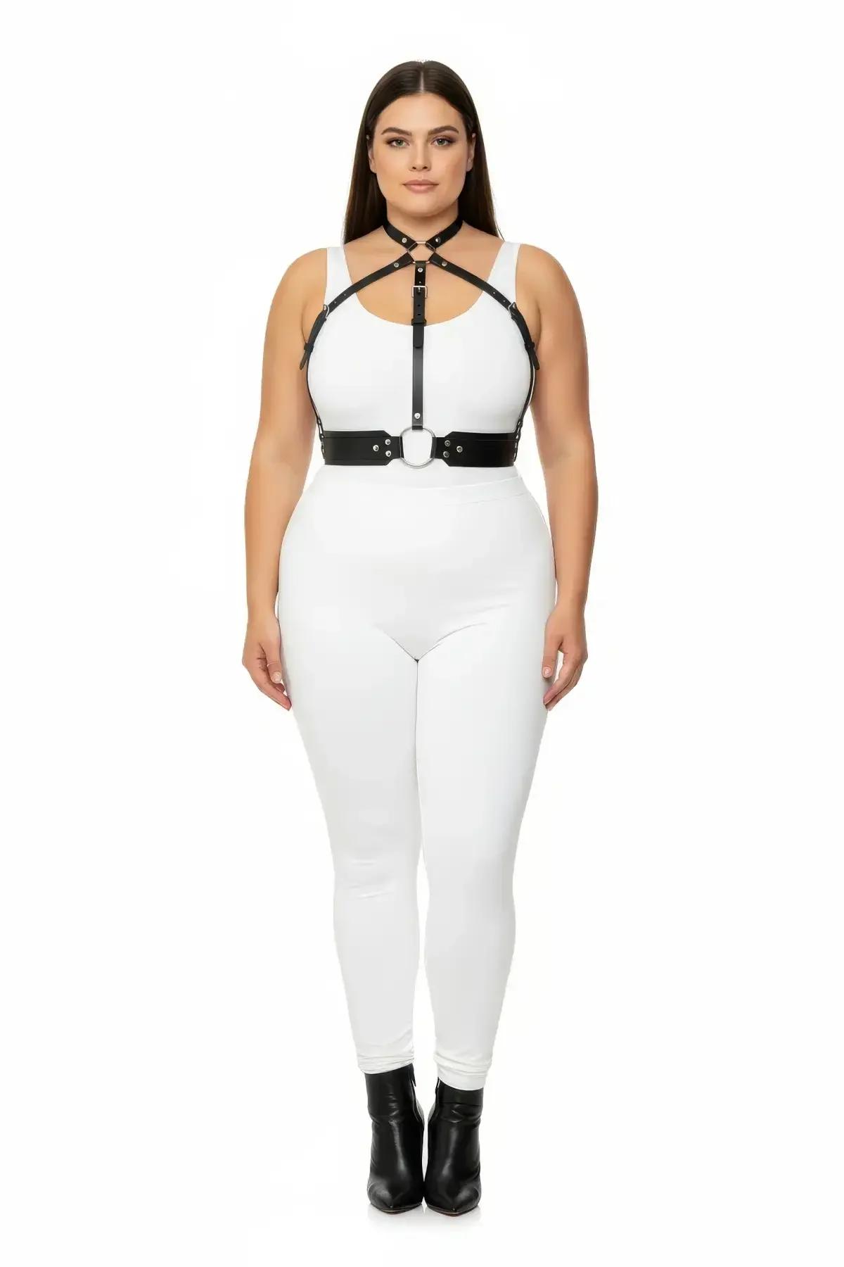 black faux leather strappy chest harness with silver O-ring underbust closure worn over white outfit plus size model