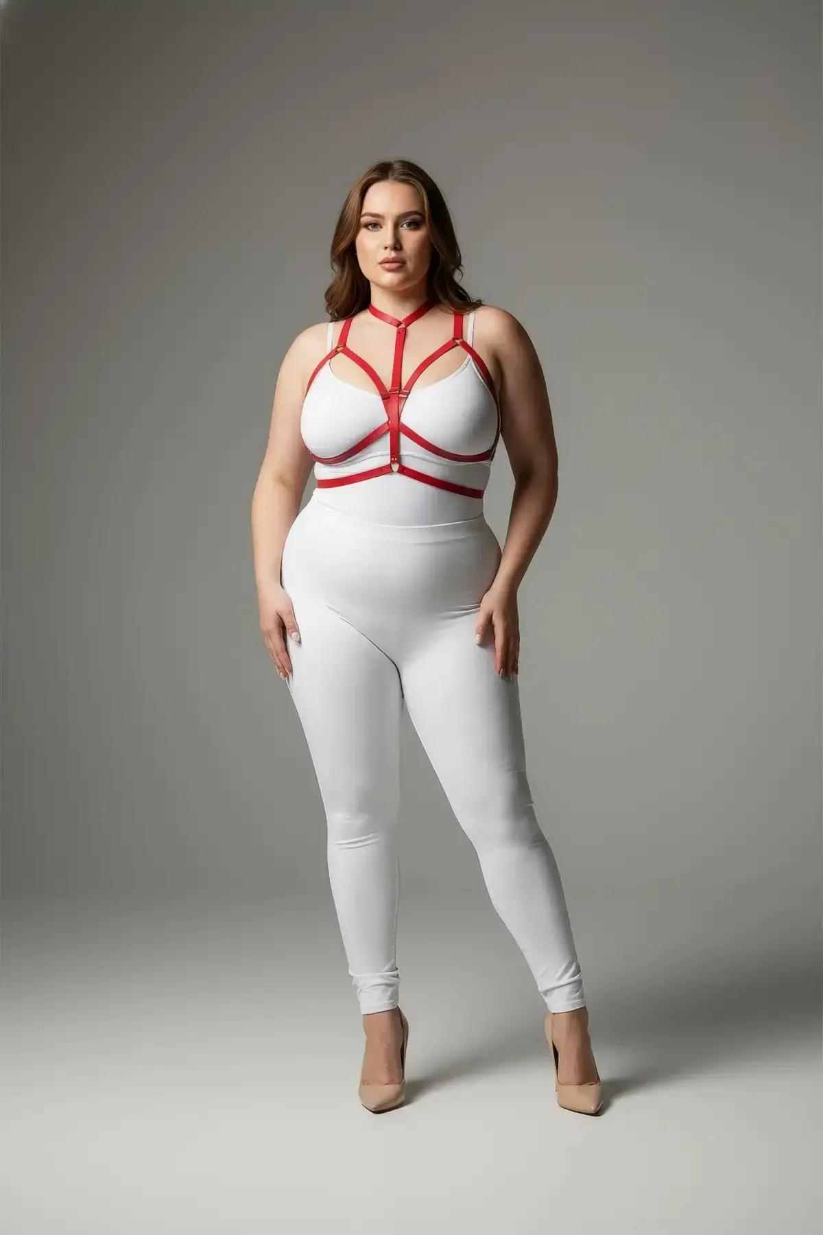 Red vegan leather strappy chest harness with geometric cage straps and silver O-ring on plus-size model