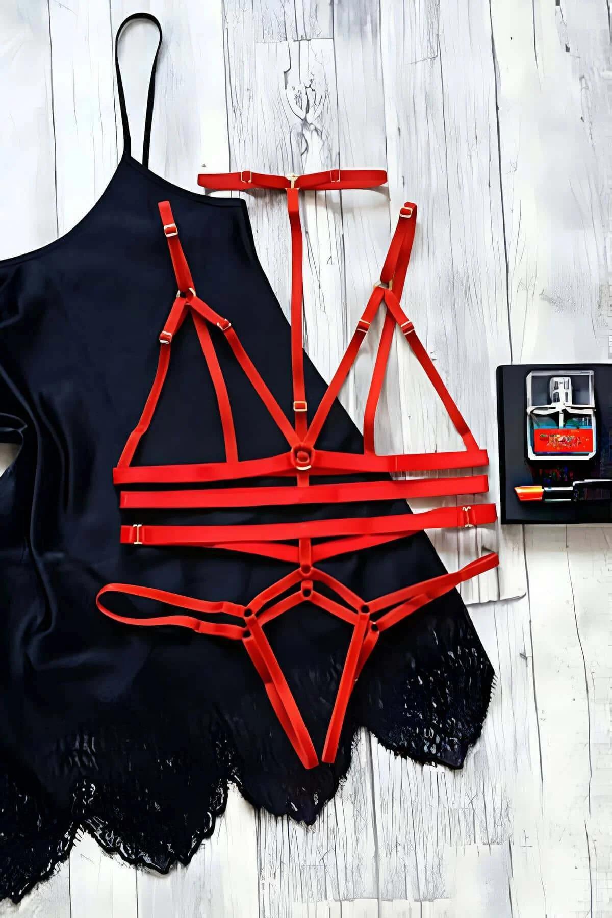 red elastic strap harness set bra thong cage gold hardware adjustable sliders flat lay