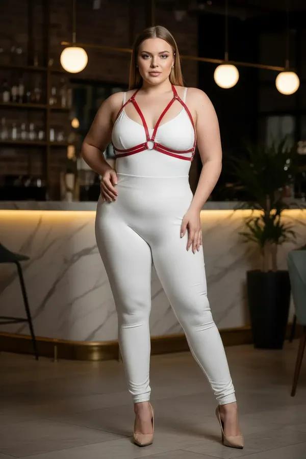 red faux leather chest harness bra with silver O-ring center worn over white bodysuit, adjustable straps