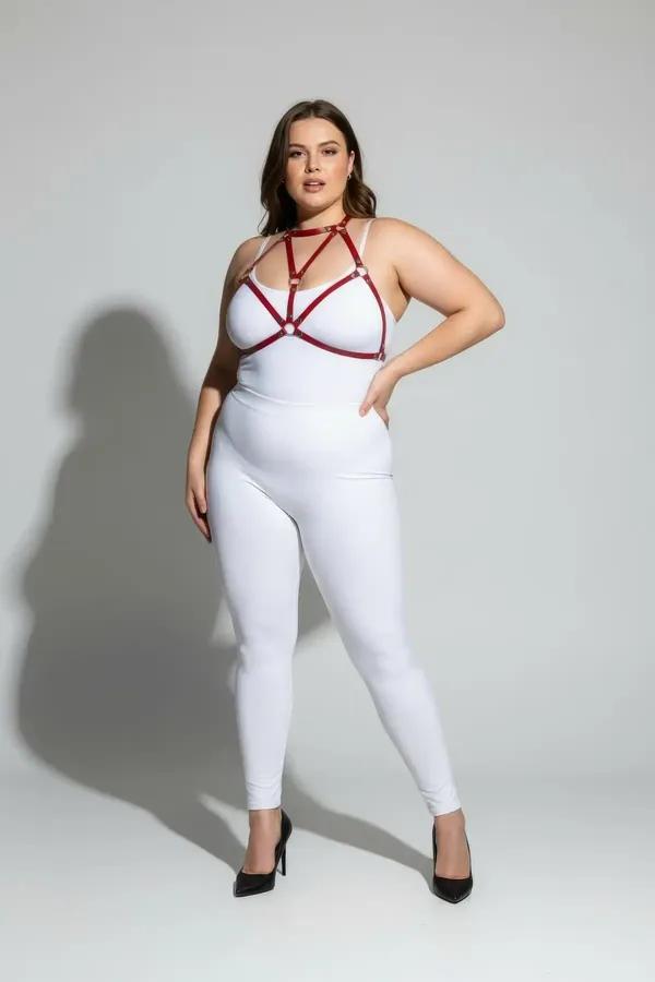 red faux leather strappy body harness with gold O-ring connectors worn as chest harness over white bodysuit