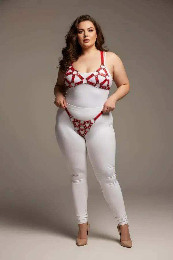 red faux leather cage bra and panty harness set with chrome O-rings and geometric strap pattern on plus-size model
