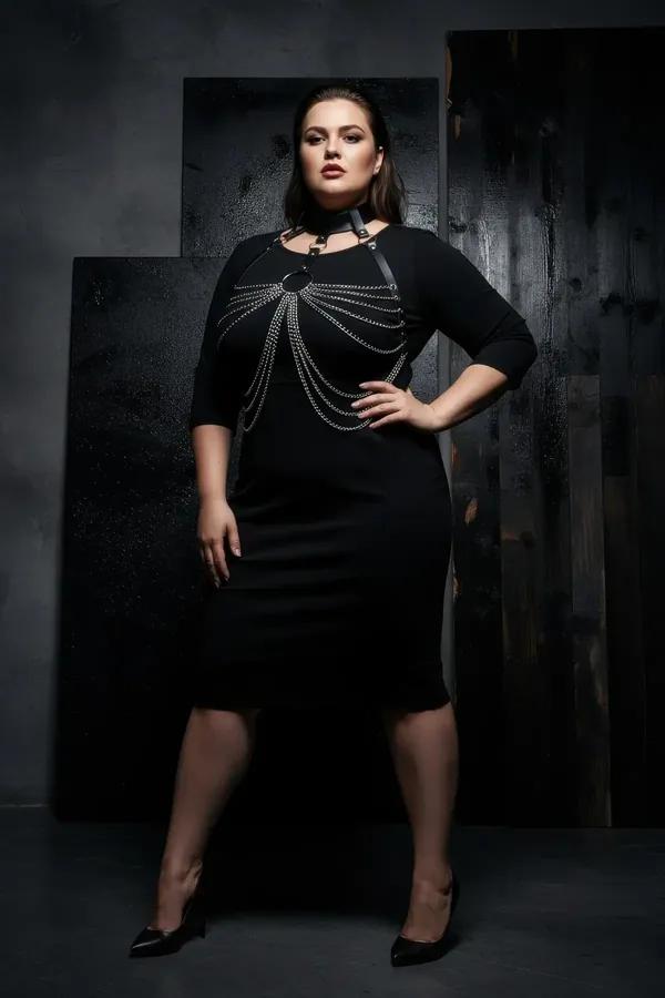 Black faux leather chain body harness with choker collar and cascading silver O-ring chains worn over black dress