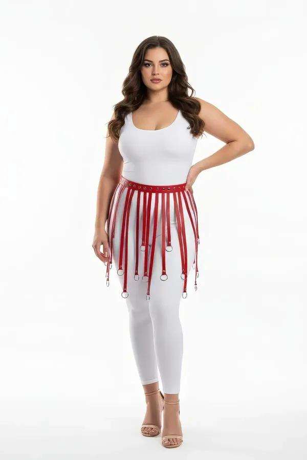 Red faux leather fringe skirt harness with silver O-ring tipped vertical straps worn over white jeans
