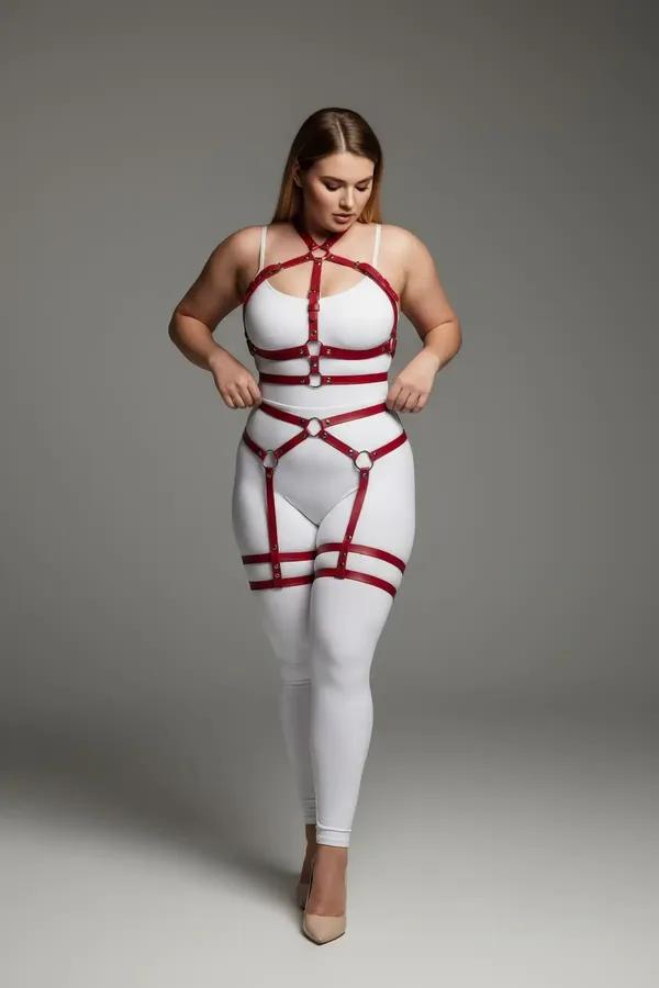 red vegan leather full body harness with silver O-rings and adjustable thigh garter straps on plus-size model