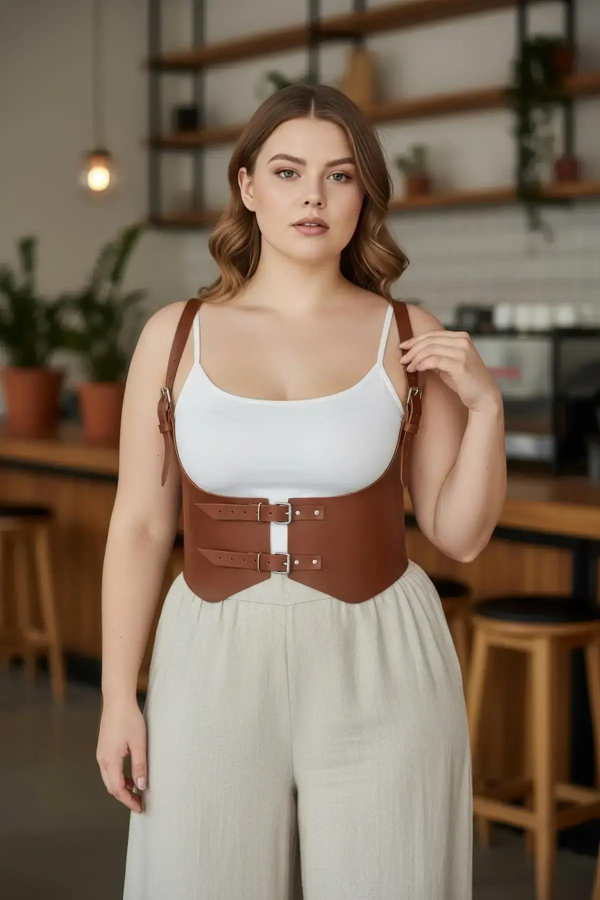 tan faux leather underbust harness waist belt with gold double buckles and adjustable shoulder straps on plus size model