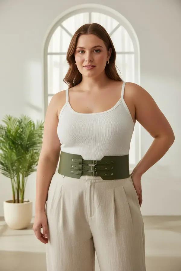 olive green wide waist cincher harness with three silver buckle straps worn over cream bodysuit