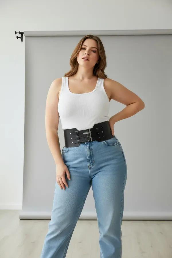 black faux leather wide waist harness belt with three silver buckles and stud detail worn over white tank top