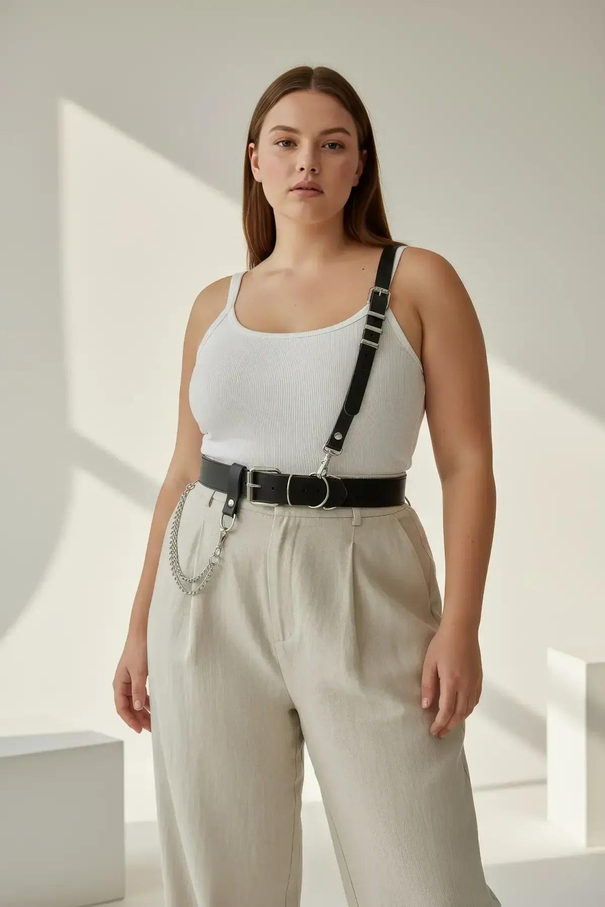 Black faux leather asymmetrical belt harness with single right-shoulder strap, silver O-ring buckle, and detachable double-st