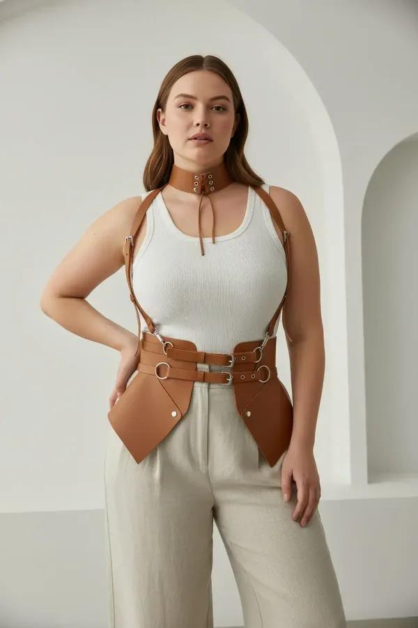 tan faux leather waspie corset harness with choker and adjustable silver-buckle shoulder straps worn over white top