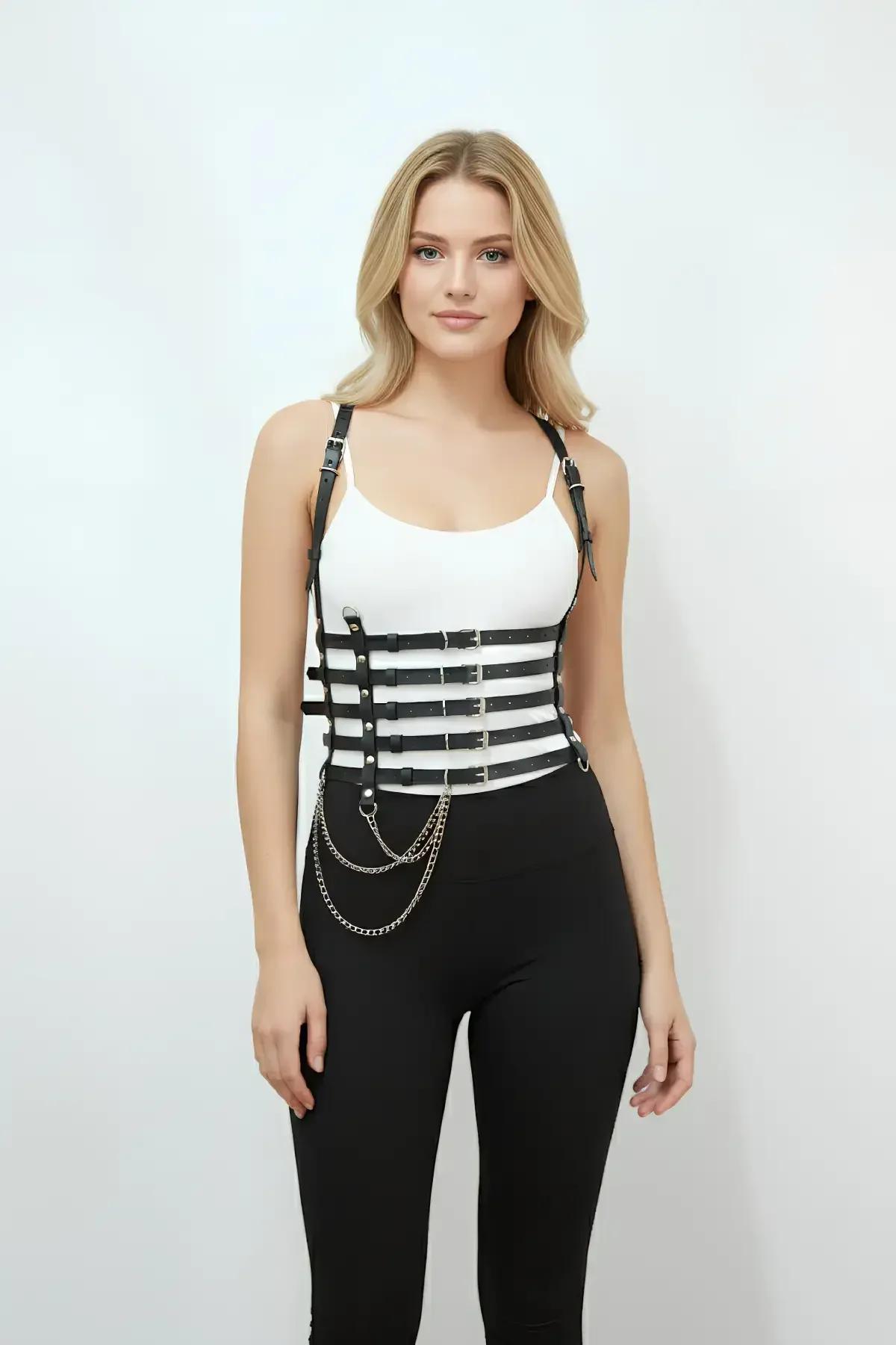 black faux leather multi-strap waist harness with silver buckles and detachable draping chain worn over white tank