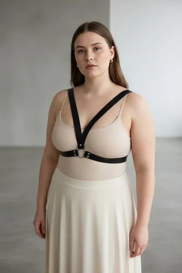 black faux leather minimalist chest harness with silver O-ring underbust band worn over white top street style