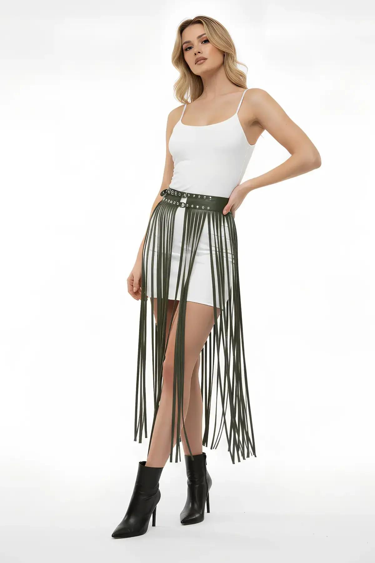 Olive green faux leather fringe belt skirt with silver stud grommet waistband worn over white shorts