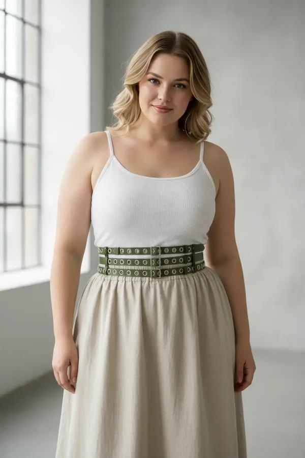 Khaki faux leather triple-row grommet waist harness belt with silver eyelets worn over cream linen dress