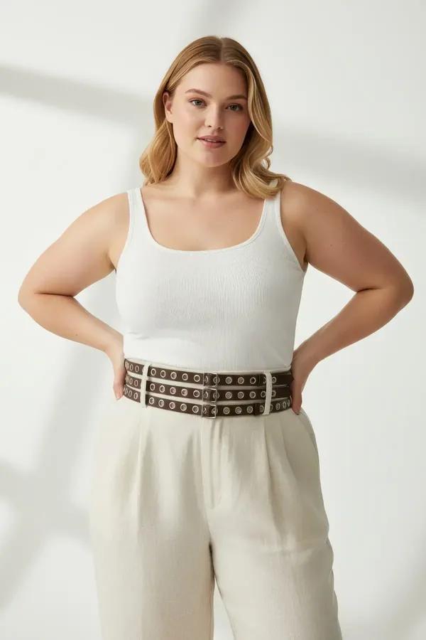 dark brown faux leather three-strap waist harness belt with polished silver metal eyelets worn at the waist