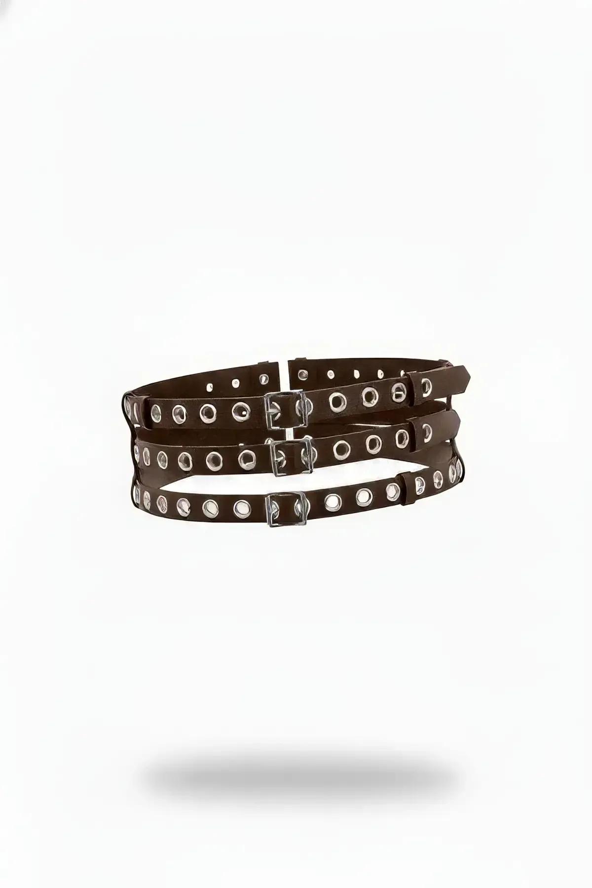dark brown triple-strap eyelet underbust harness with silver buckles and evenly spaced silver eyelets on white background