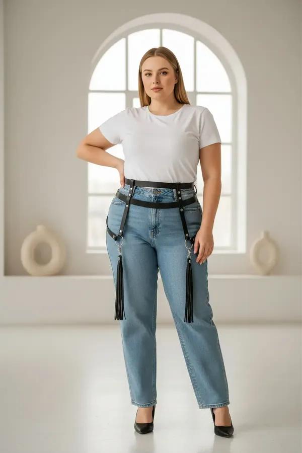 black faux leather waist harness with detachable tassel garters and silver stud hardware worn over jeans