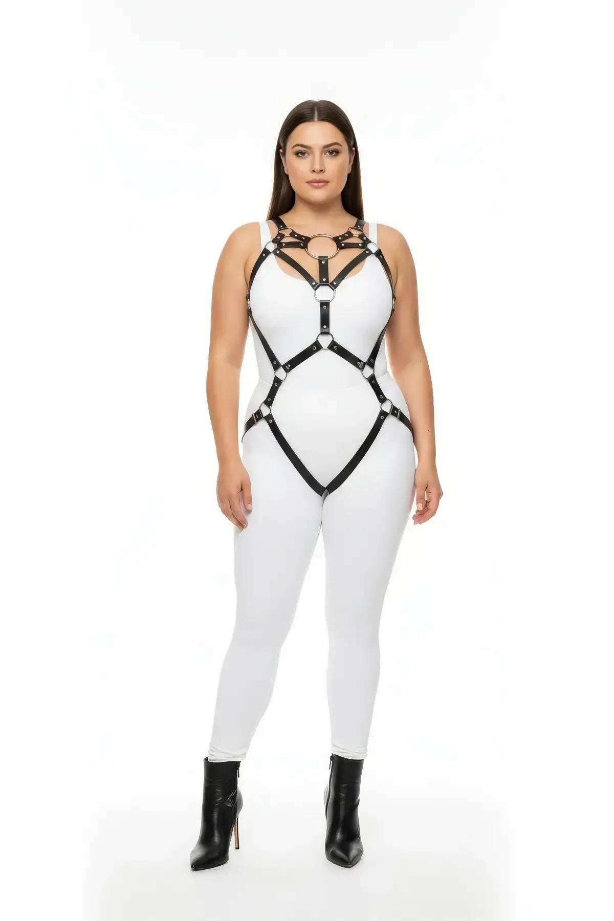 Black faux leather full body harness with central O-ring chest cage and garter straps, worn over white bodysuit
