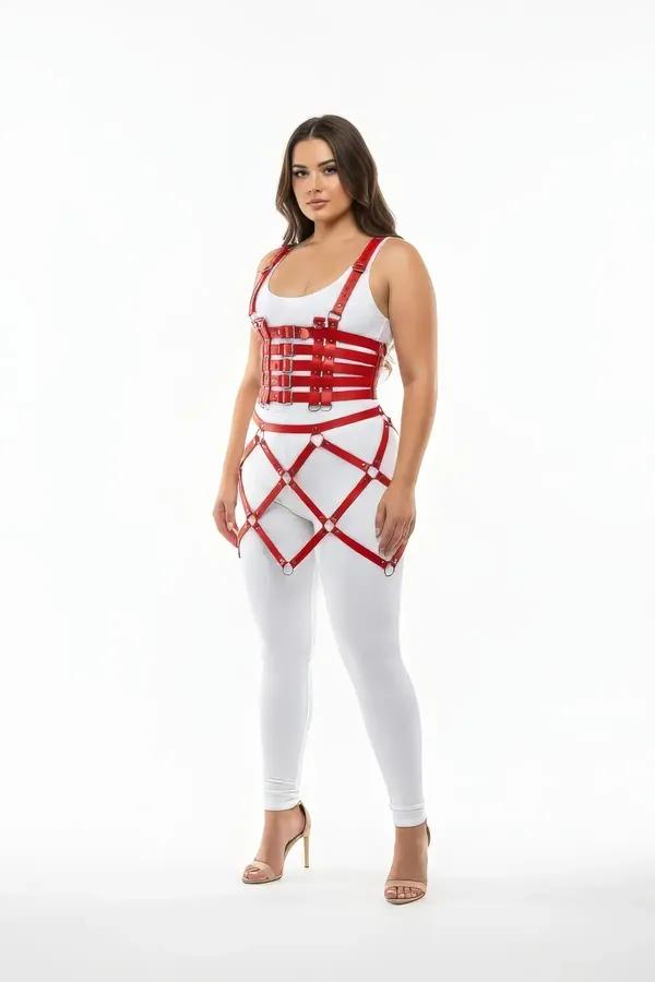 Red faux leather caged harness skirt and bustier set with silver O-rings worn over white bodysuit and leggings