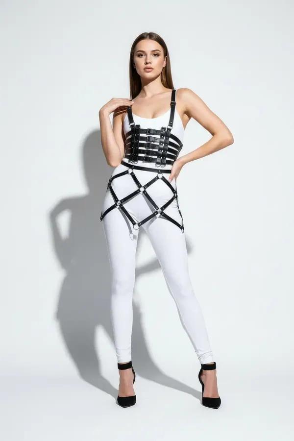Black faux leather multi-strap body harness with geometric diamond cage over hips, silver O-ring and D-ring hardware, worn ov